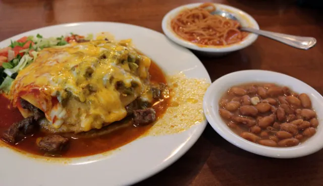 Cocina Azul signature dishes Carne Adovada, Green Chile Chicken Enchiladas, Blue Corn Tacos, Stuffed Sopapillas, Chile Rellenos.